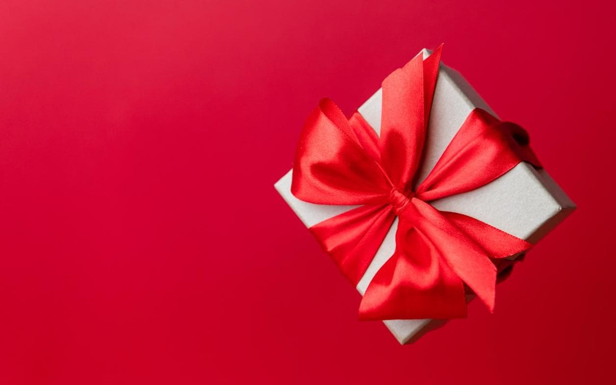 Wrapped gift box with a red bow